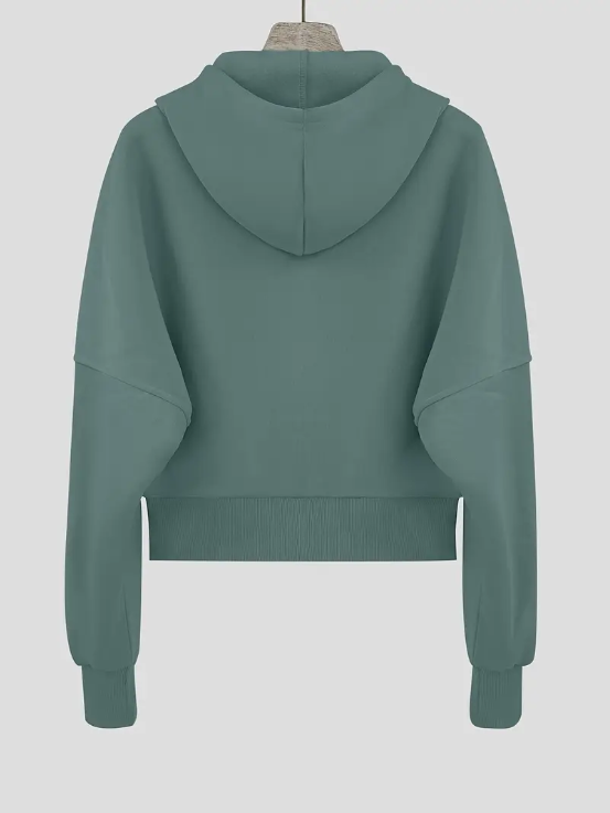 Sweat à capuche vert menthe pour femme, manches longues, coupe ample, style décontracté, idéal pour mode automne-hiver, fond gris clair.