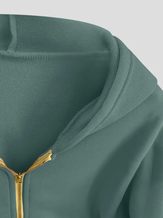 Sweat à capuche vert avec fermeture éclair dorée, tissu doux et confortable, style décontracté. Mode automne-hiver, vêtement tendance.