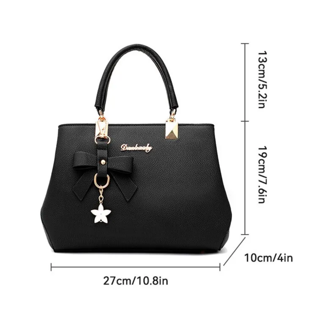 Sac à main noir élégant avec nœud décoratif, pendentif étoile, dimensions 27x10x19 cm. Accessoire mode femme chic, parfait pour toutes occasions.