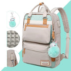 Sac à dos beige et vert menthe avec porte-clés licorne, poches multiples, détails en cuir, design ergonomique. Accessoire mode tendance et pratique.
