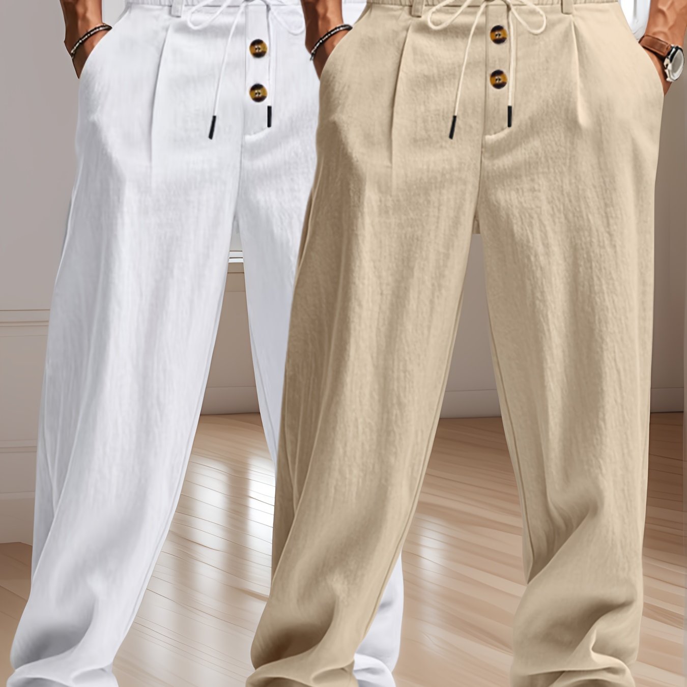 Deux pantalons en lin, l'un blanc et l'autre beige, avec cordons de serrage et boutons, posés sur un sol en bois clair dans une pièce lumineuse.