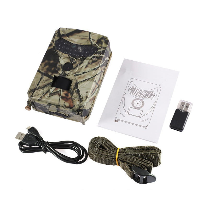 Appareil photo de chasse camouflage avec câble USB, sangle de fixation et manuel. Idéal pour surveillance faune, photographie nature.
