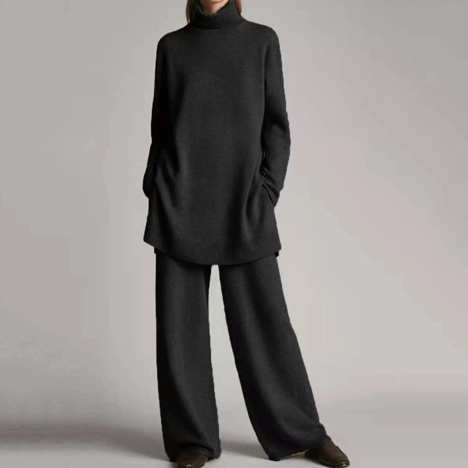 Femme portant un ensemble pull et pantalon ample gris foncé, style décontracté et élégant, mode automne-hiver, vêtements confortables et tendance.