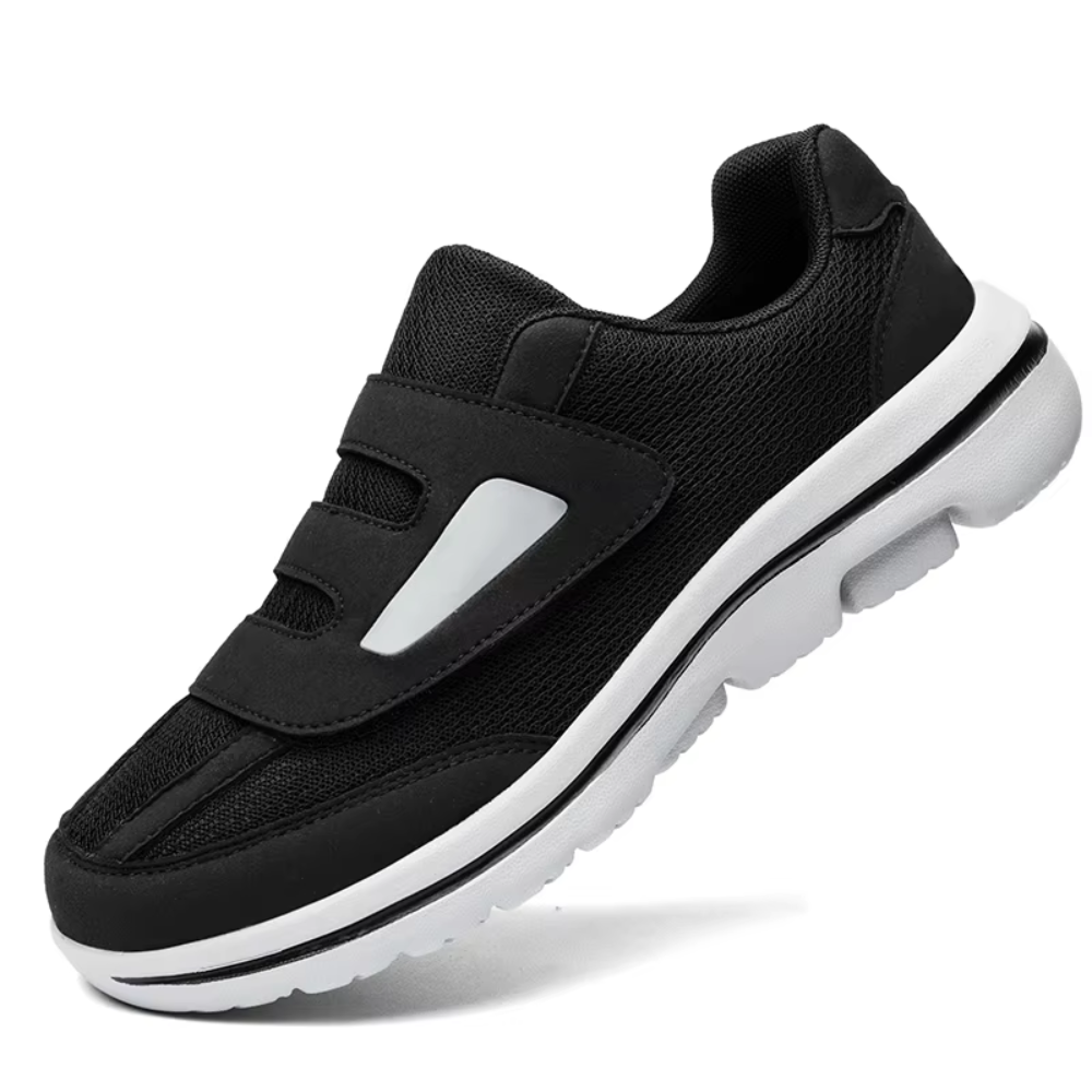 Chaussure de sport noire pour homme avec semelle blanche, design moderne et confortable, idéale pour la course et le fitness.