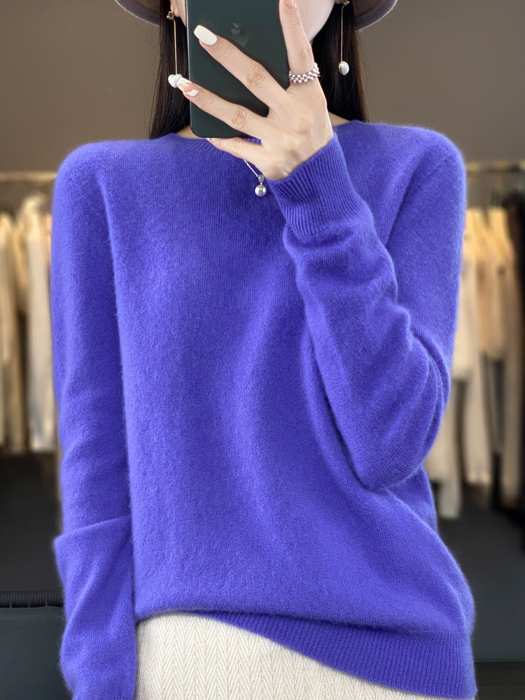 Femme portant un pull en cachemire violet, tenant un smartphone. Mode automne-hiver, élégance, confort, tendance vêtements chauds.