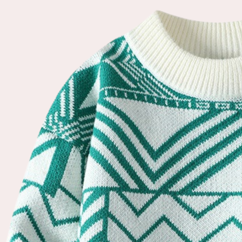 Pull en tricot vert et blanc avec motif géométrique, col rond côtelé. Mode hiver, style moderne, tendance vêtements chauds.