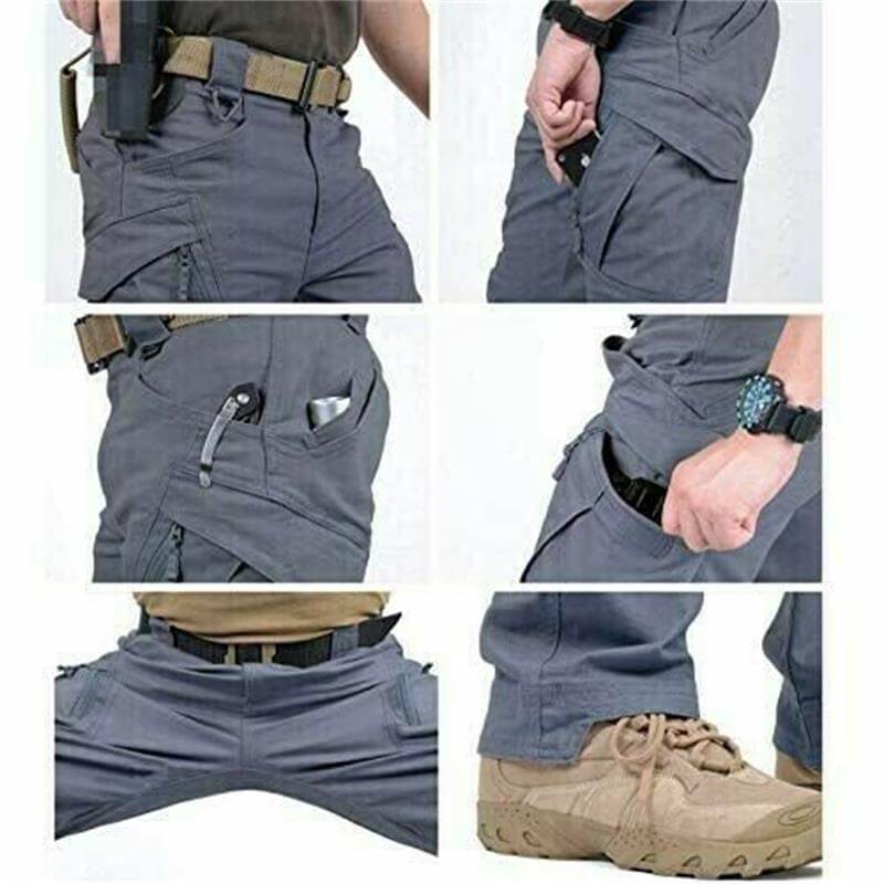 Pantalon tactique gris avec poches multiples, ceinture renforcée, montre noire, couteau de poche, chaussures robustes. Idéal pour activités extérieures.