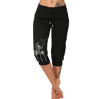Pantalon capri noir femme avec motif pissenlit blanc, taille élastique, cordon de serrage, mode décontractée, idéal pour l'été et le yoga.