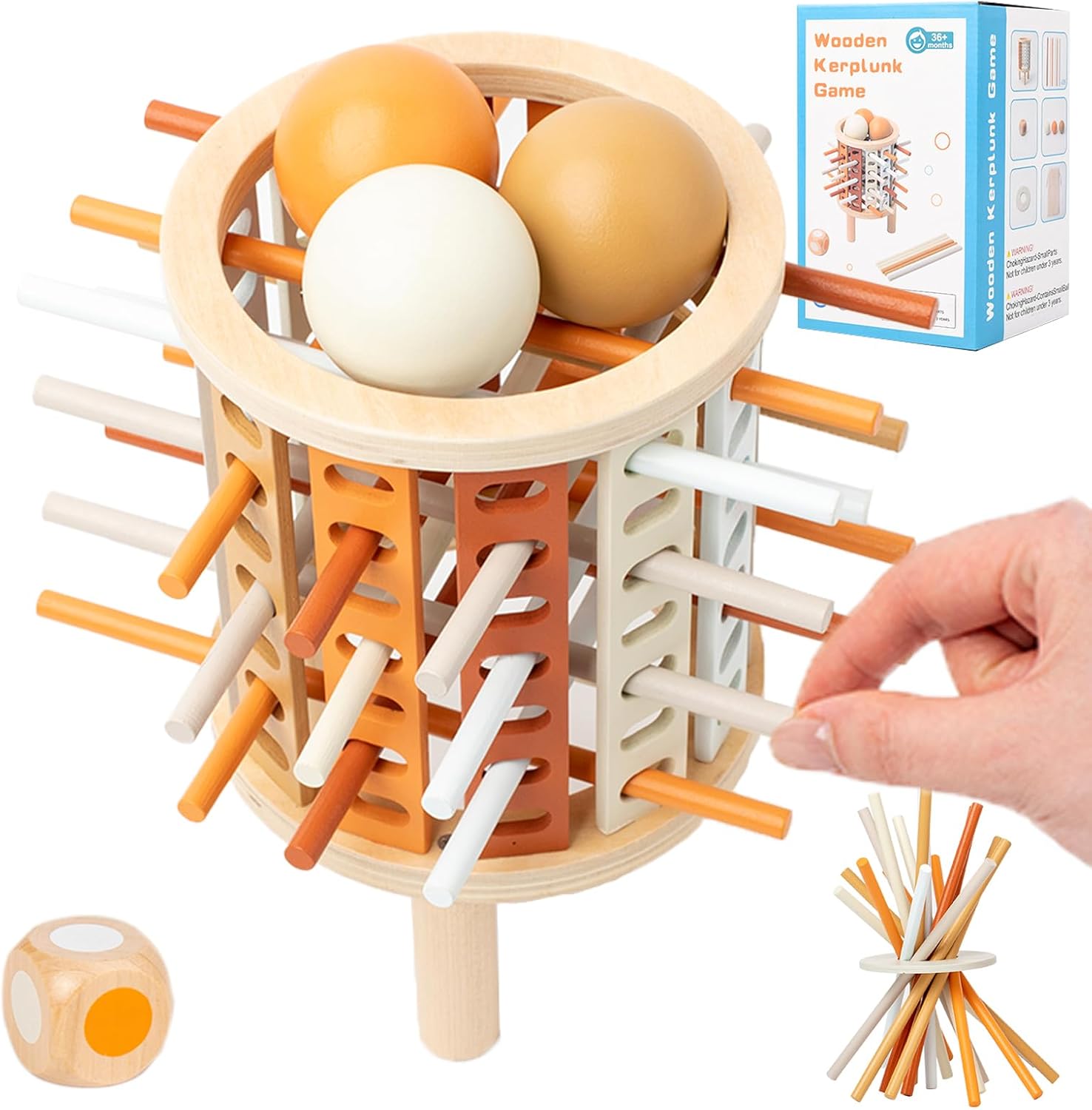 Jeu de société en bois Kerplunk avec bâtons colorés et boules, boîte d'emballage visible, main retirant un bâton, idéal pour enfants et familles.