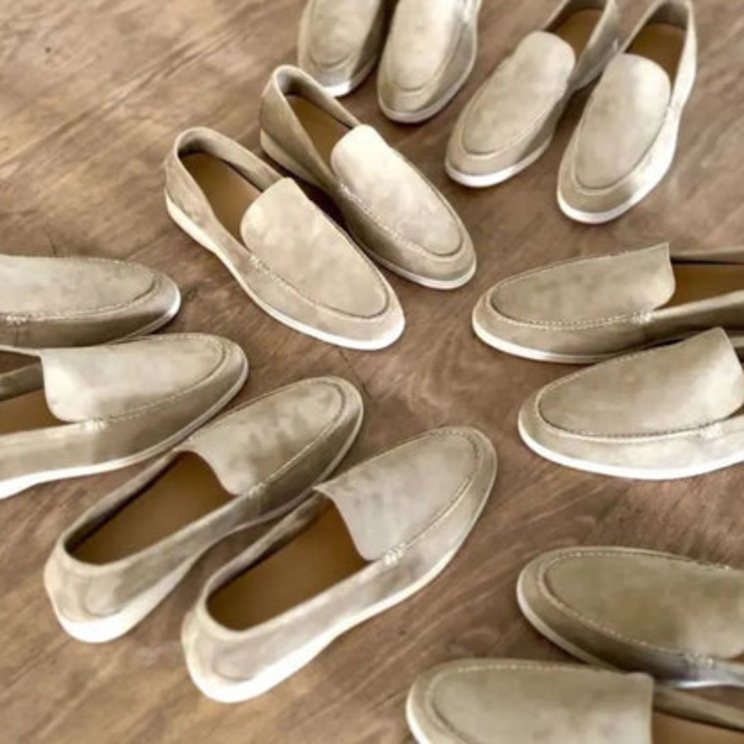 Chaussures mocassins en daim beige disposées en cercle sur un sol en bois. Style élégant et décontracté, parfait pour la mode masculine moderne.