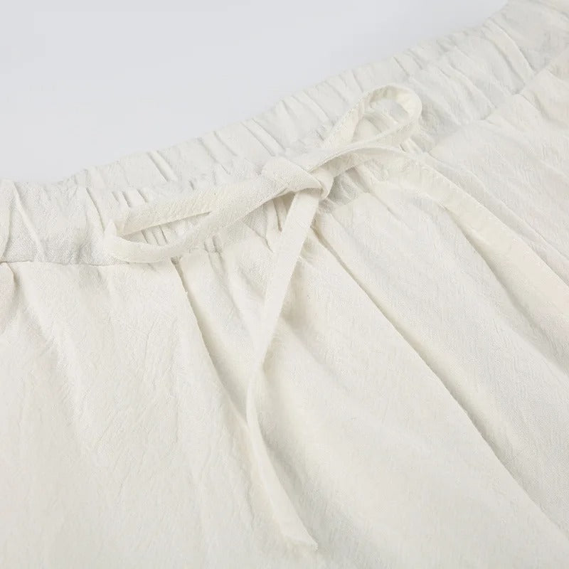 Pantalon en lin blanc avec taille élastique et cordon, style décontracté, tissu léger et respirant, idéal pour l'été et les tenues décontractées.