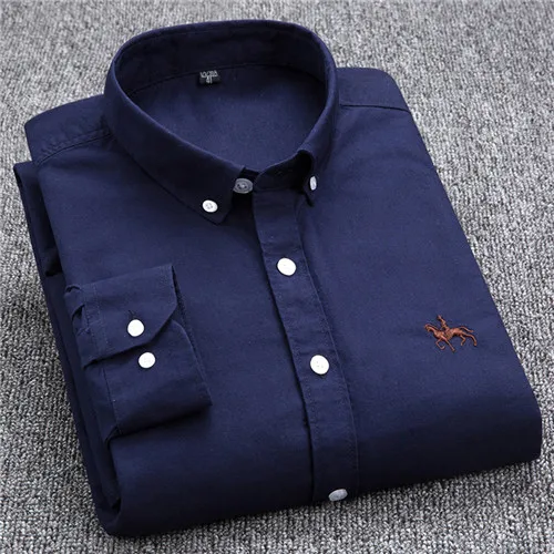 Chemise homme bleu marine pliée, boutons blancs, logo brodé, sur fond gris. Mode masculine élégante, vêtement classique, style décontracté.