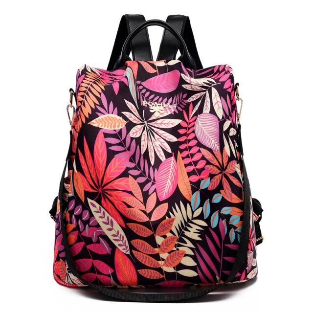 Sac à dos floral coloré avec motifs de feuilles roses et oranges, design moderne et élégant, idéal pour la mode féminine et les accessoires tendance.