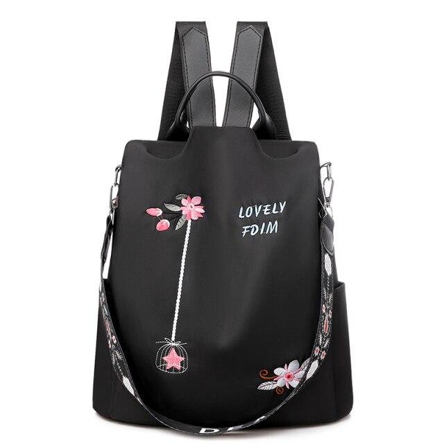 Sac à dos noir élégant avec broderie florale rose, texte "Lovely FDM", bretelles ajustables, design moderne et pratique pour femmes.