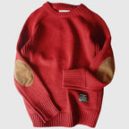 Pull rouge en laine avec coudières marron, manches longues, col rond, style décontracté. Mode automne-hiver, vêtement chaud et confortable.