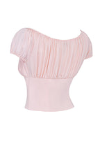 Top court rose pâle à manches bouffantes, encolure bardot, style chic et élégant, idéal pour tenues estivales et soirées décontractées.