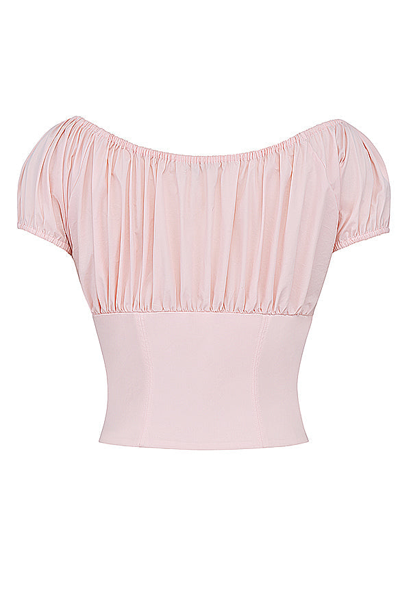 Top court rose pâle à manches bouffantes, encolure bardot, style chic et élégant, idéal pour tenues estivales et soirées décontractées.