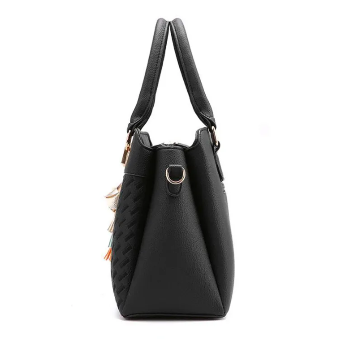 Sac à main noir en cuir texturé avec anses robustes, design élégant et moderne, idéal pour la mode féminine et les accessoires tendance.