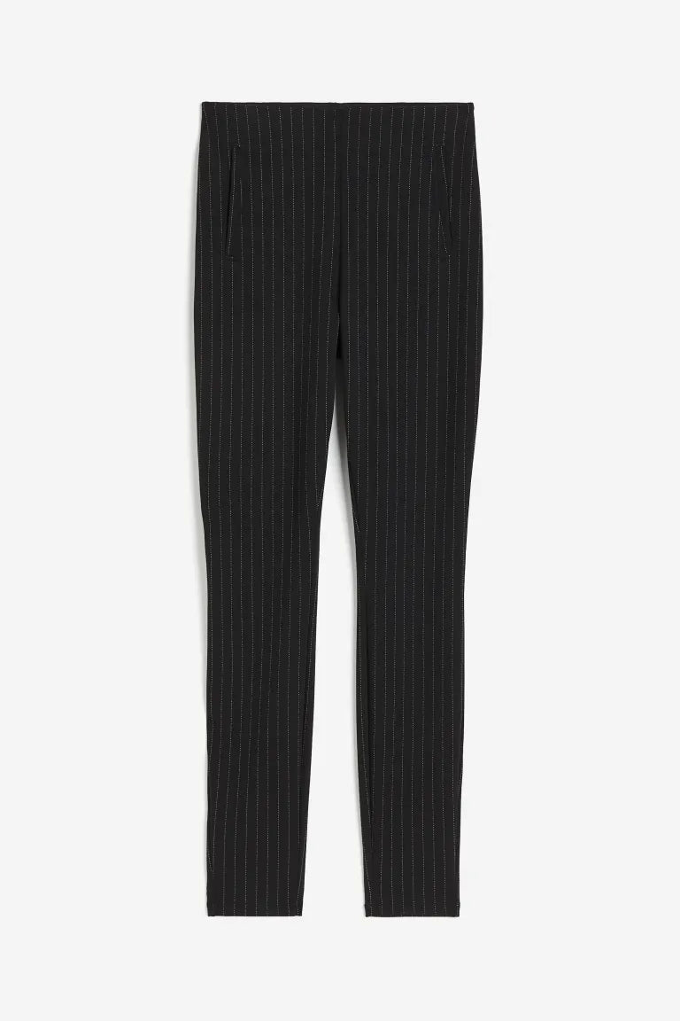 Pantalon noir à rayures verticales blanches, coupe ajustée, style élégant et moderne, idéal pour tenues professionnelles ou occasions formelles.