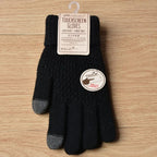 Gants noirs tactiles pour écran, avec bouts de doigts gris, sur fond en bois. Accessoire hiver, compatible smartphone, étiquette en anglais et japonais.