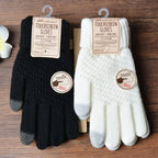 Gants tactiles noirs et blancs en laine, étiquetés, posés sur une table en bois. Accessoires d'hiver, compatibles écrans tactiles.