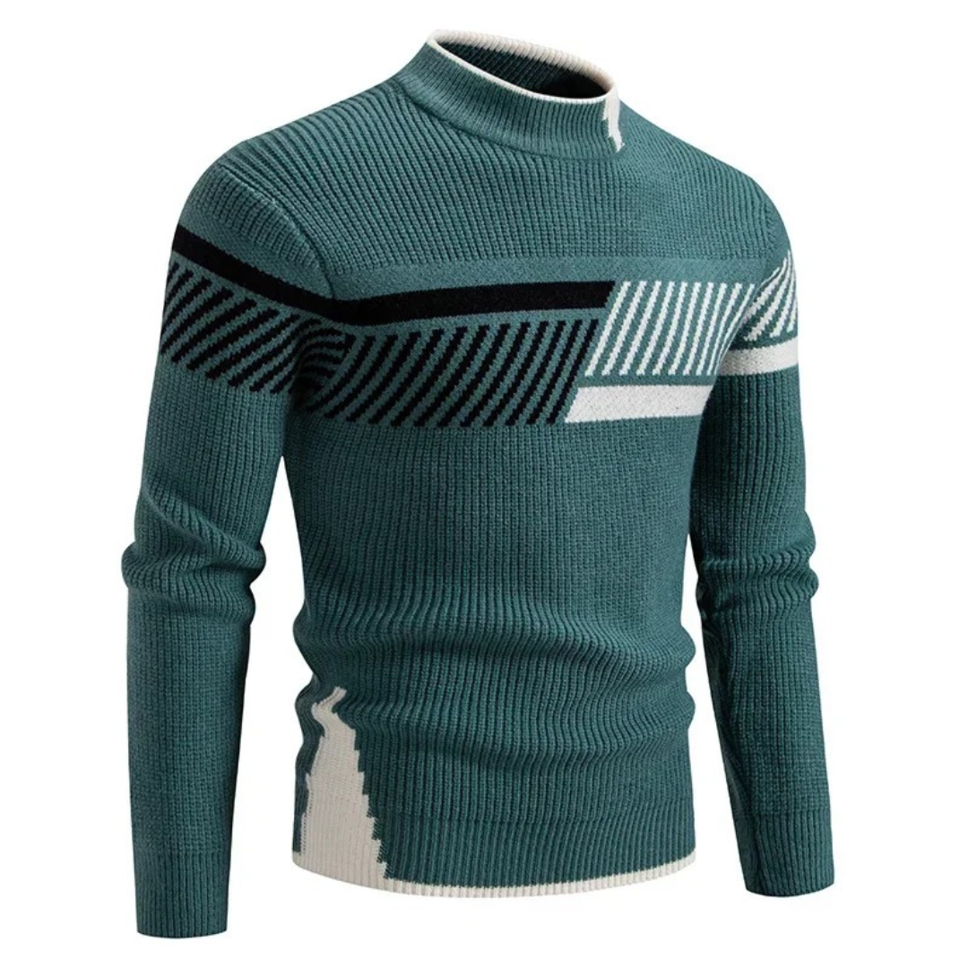 Pull en tricot vert avec motifs géométriques noirs et blancs, col montant. Mode homme automne-hiver, style moderne et élégant.