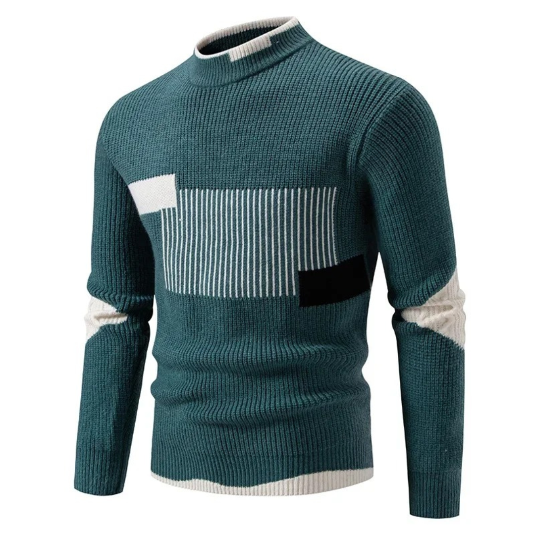 Pull-over en tricot vert avec motifs géométriques blancs et noirs, col rond, manches longues. Mode homme automne-hiver, style moderne et élégant.