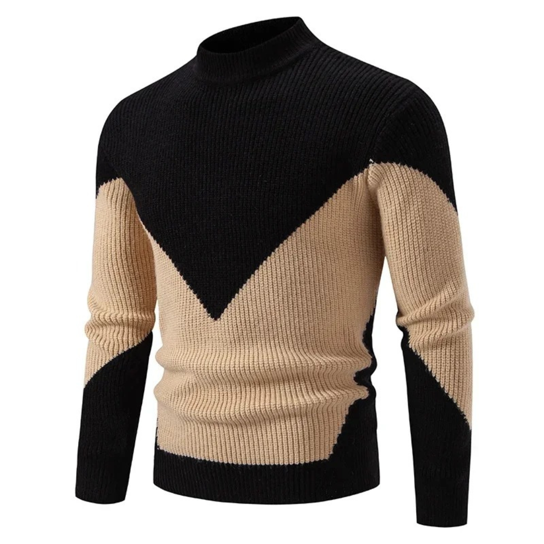 Pull en tricot noir et beige à col rond, motif géométrique en V, manches longues. Mode homme, style automne-hiver, tendance élégante.