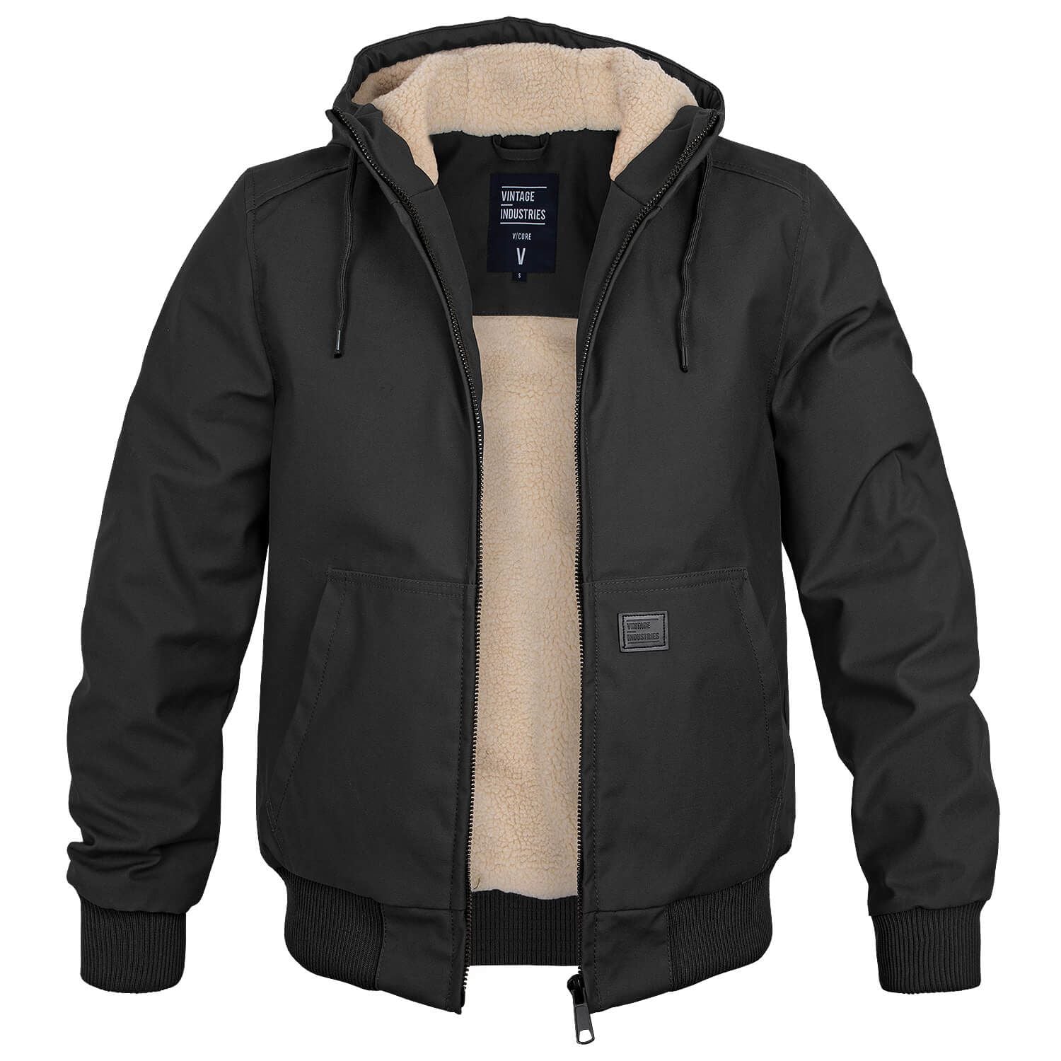 Veste homme noire à capuche, doublure en fourrure synthétique beige, fermeture éclair, poches avant. Style décontracté, hiver, mode masculine.