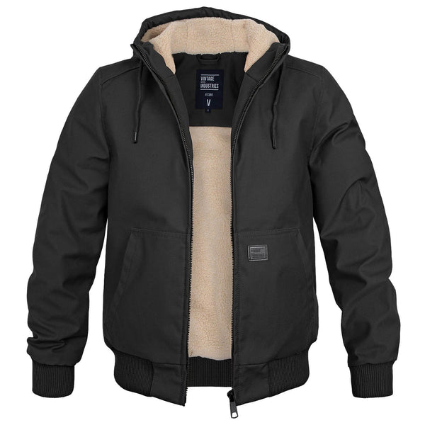 Veste homme noire à capuche, doublure en fourrure synthétique beige, fermeture éclair, poches avant. Style décontracté, hiver, mode masculine.